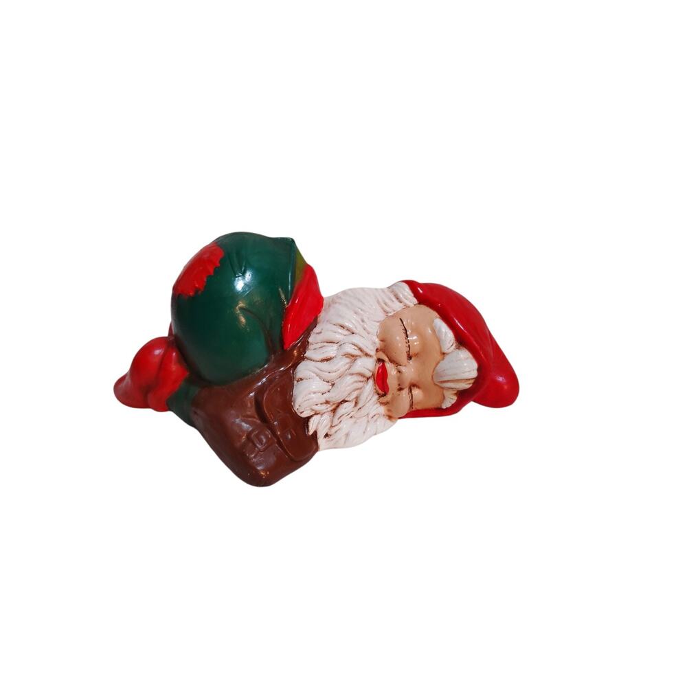 Ceramic Gnome a red cap, white textured beard, brown boots, and a green sack.